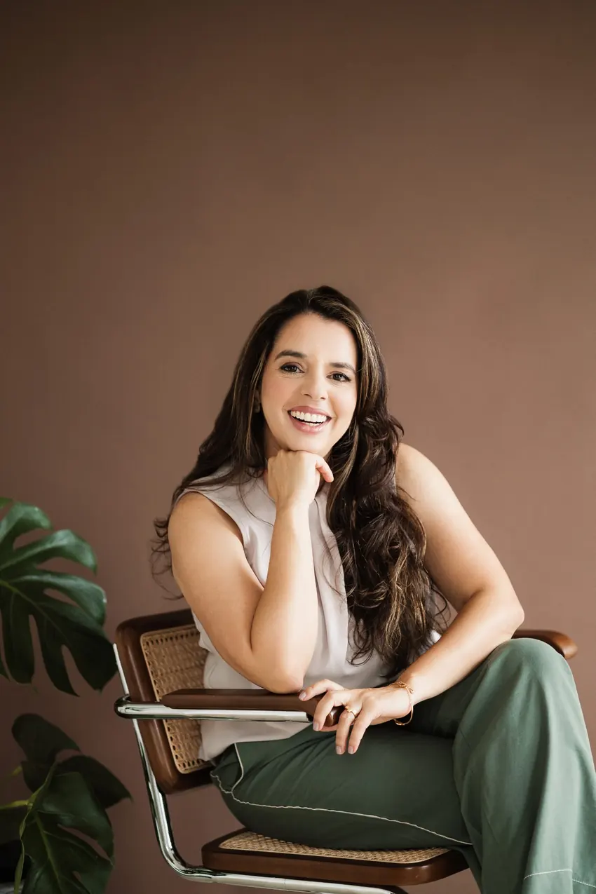 Psicóloga Kátia Landim sorrindo, sentada em uma poltrona